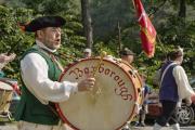 People in Historical Clothing Marching in Parade
