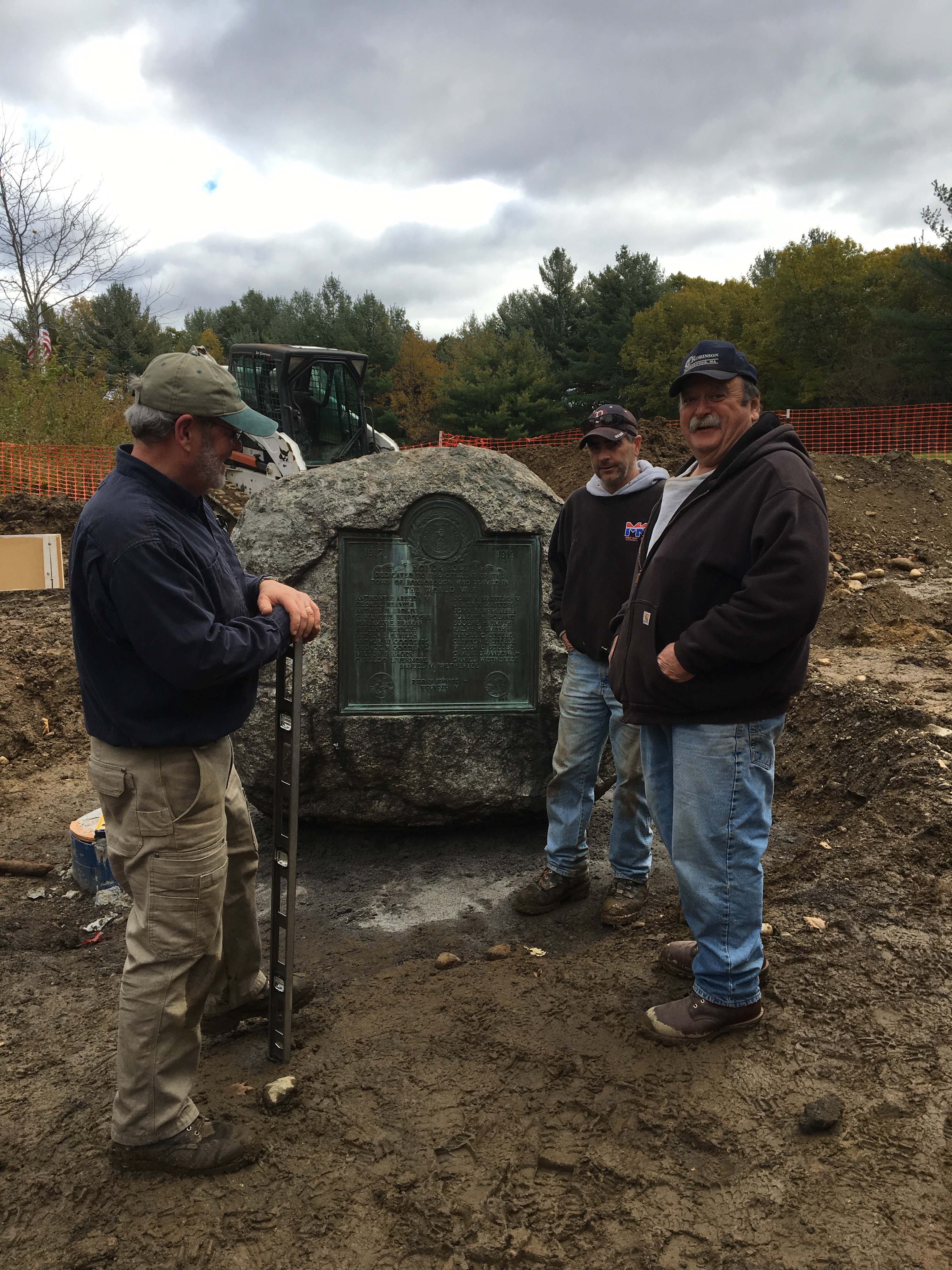 Three Men Moving a Monument to Its New Home